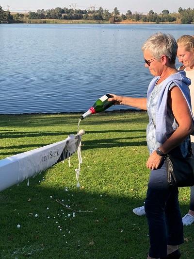 Theresia Stark pours champagne on the WUBC boat named after John Stark
